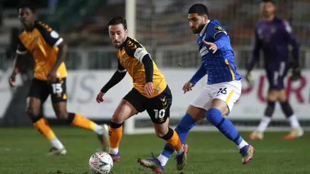 Newport's Josh Sheehan with Brighton's Alireza Jahanbakhsh