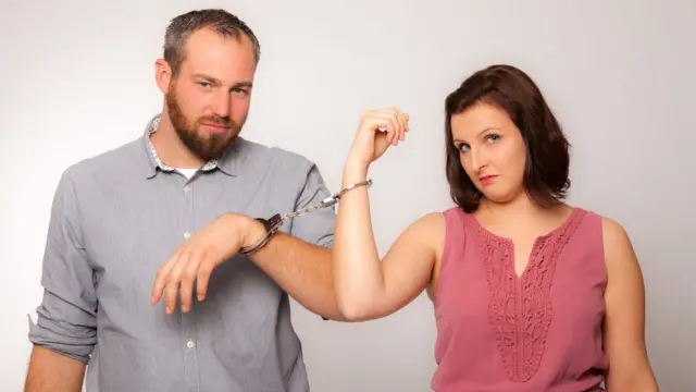 Man and woman handcuffed together