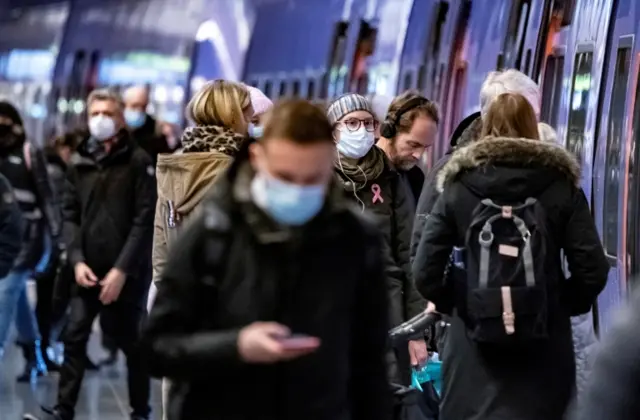 Passengers wearing protective masks walk on a platform at Malmo Central Station on January 7, 2021. Photo by TT News Agency/Johan Nilsson