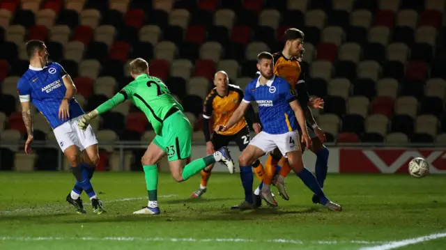 Brighton's Adam Webster scores an own goal against Newport