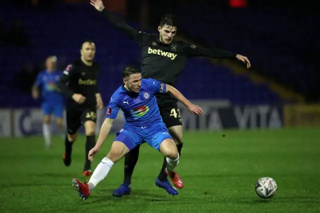 Stockport's John Rooney and West Ham's Declan Rice