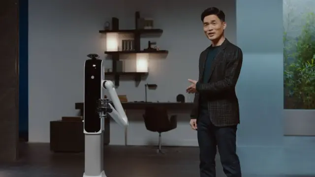 Robot Handy gives a man a glass of water