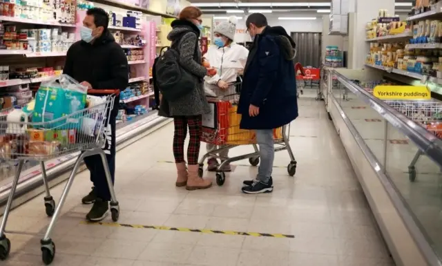 People wearing masks in supermarket