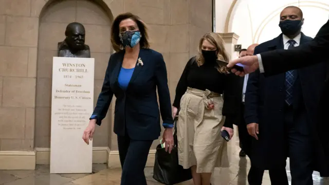 Speaker of the House Nancy Pelosi (D-CA) (L) wears a protective mask while arriving to the U.S. Capitol on January 12, 2021 in Washington, DC.