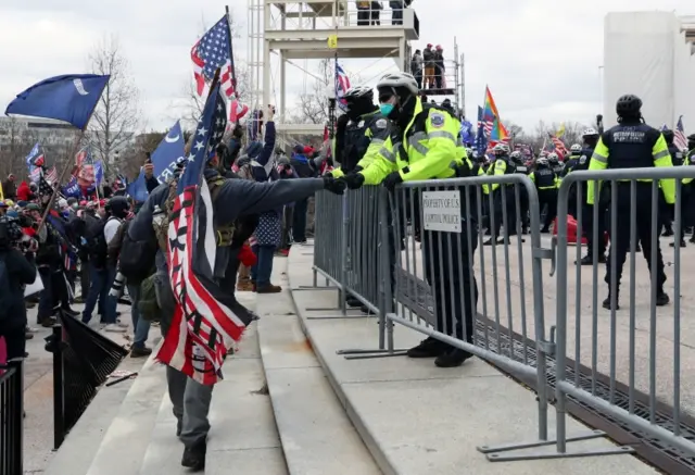 A person fist-bumps a member of US Capitol Police