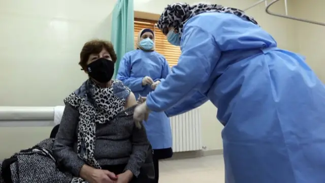 A woman receives a Covid-19 vaccine at a medical centre in Amman, Jordan (13 January 2021)