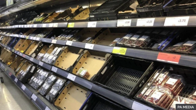 Empty food aisle at Sainsbury's in Belfast on Monday