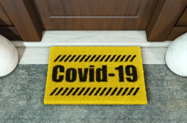 Welcome mat with Covid-19 written on it