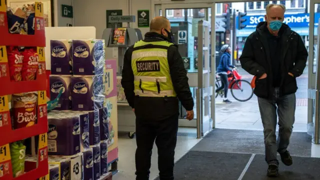 A man wearing a face mask inside a shop