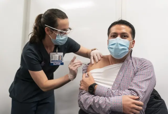 A nurse vaccinated a fellow nurse in Seattle, Washington state. File photo