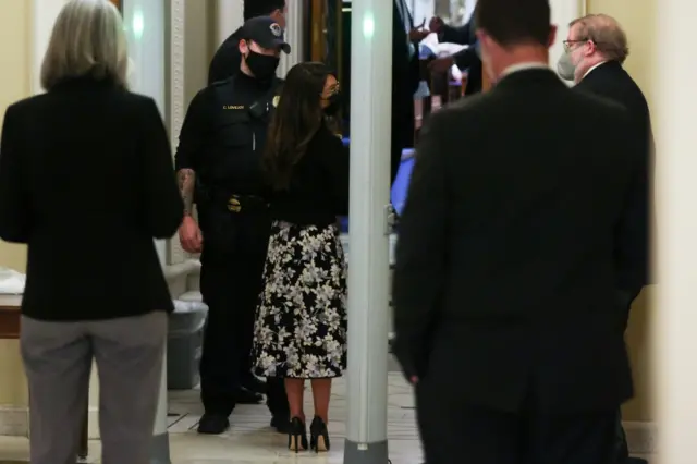 U.S. Representative Lauren Boebert (R-CO) is temporarily stopped by Capitol Police as she passes through metal detectors at a new security checkpoint outside the House floor during debate on a resolution demanding Vice President Pence and the cabinet remove President Trump from office, at the U.S. Capitol in Washington, U.S. January 12, 2021.