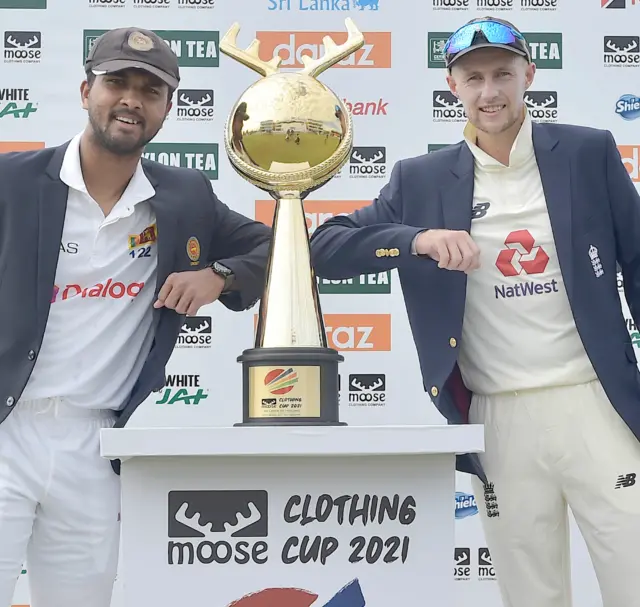 Dinesh Chandimal and Joe Root with the Moose Cup Clothing trophy