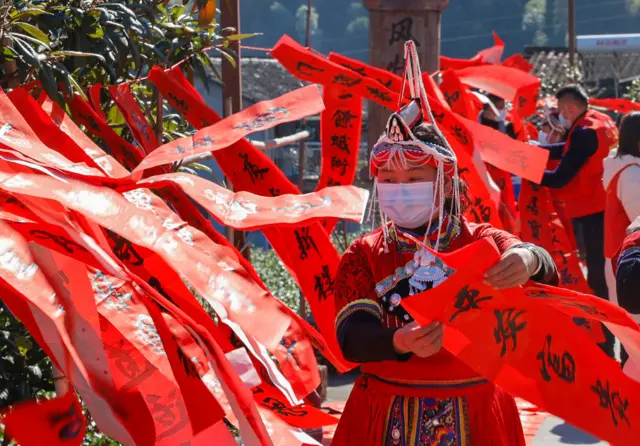 People dry the Spring Festival Couplets (or Chunlian) which are written by members of a painting and calligraphy association to welcome the Chinese lunar new year at Jingning She Autonomous County on January 14, 2021 in Lishui, Zhejiang Province of China