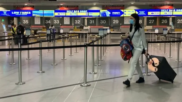 Woman wearing a face mask at an airport