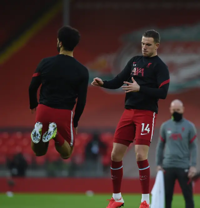 Mohammed Salah and Jordan Henderson warm up before Liverpool's match at home to Manchester United