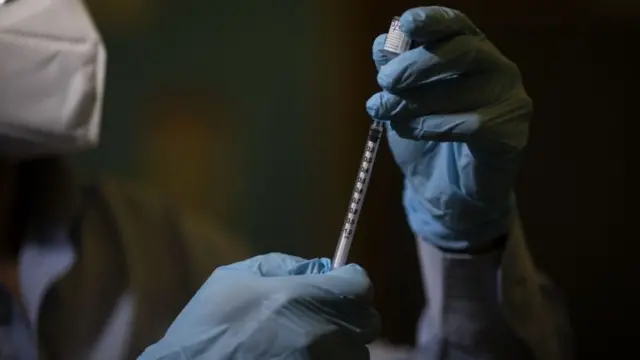 A doctor about to give a vaccine