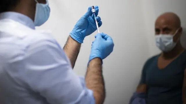 A Covid vaccine jab being prepared