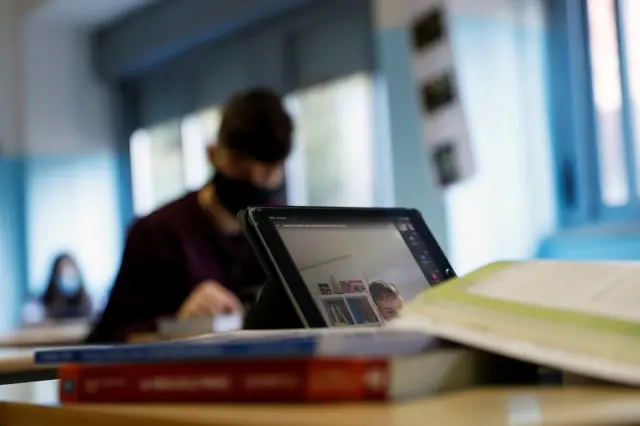 Masked pupil in classroom