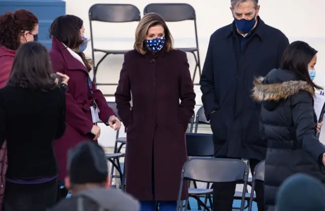 Speaker of the House Nancy Pelosi (C) reviews the preparations on the inaugural platform ahead of the presidential inauguration of Joe Biden at the US Capitol