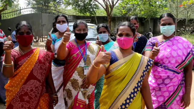 Indian school teachers and staff members of Government High School show thumbs-up for US Vice President-elect Kamala Harris at Thulasendrapuram village, south of Chennai, Tamil Nadu, India, 19 January 2021