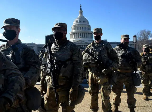 Members of the National Guard gather at a security checkpoint near the US Capitol,