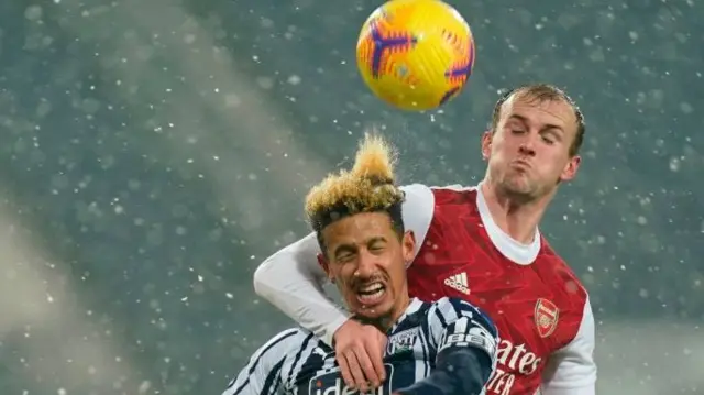 Rob Holding challenges for a header