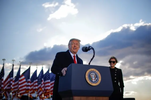 U.S. President Donald Trump speaks next to first lady Melania Trump