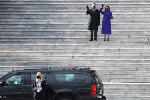 Kamala Harris and the Second Gentleman wave goodbye to the Pences