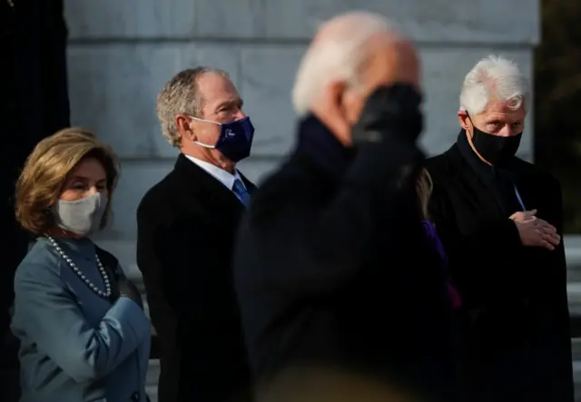 Former U.S. President Bill Clinton, former U.S. President George W. Bush and his wife Laura Bush look on