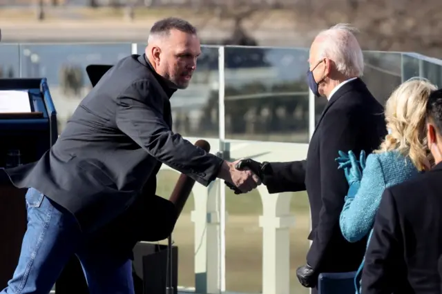 U.S. President Joe Biden shakes hands with singer Garth Brooks