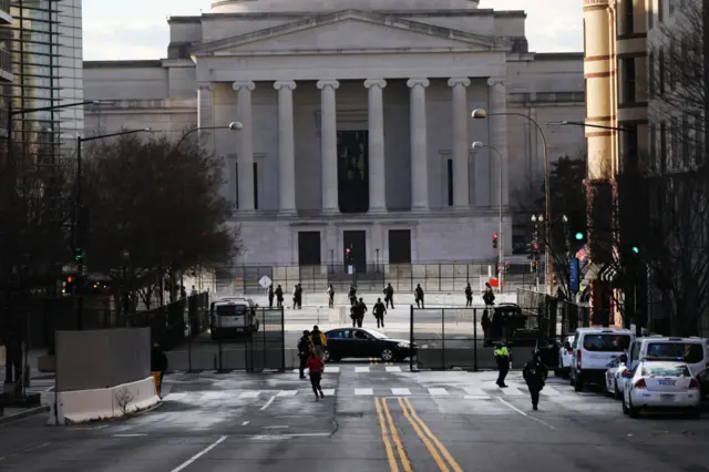 Law enforcement officers patrol the streets ahead of the inauguration