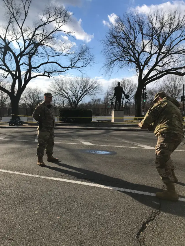 National Guardsman Darrell Kyle (right) takes photos