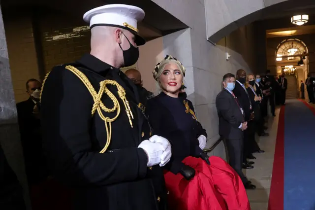 : Lady Gaga with U.S. Marine escort Capt. Evan Campbell to sing the National Anthem at the inauguration