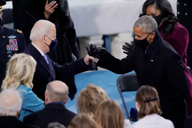 U.S. President-elect Joe Biden greets former U.S. President Barack Obama upon arriving to Biden's inauguration