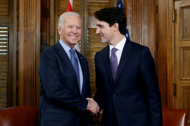 Canada's Prime Minister Justin Trudeau (R) shakes hands with US Vice-President Joe Biden in 2016