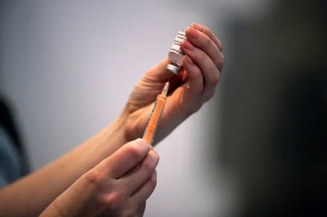 A vaccine shot being prepared