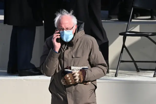 Vermont Senator Bernie Sanders is seen on the phone before US the inauguration