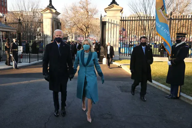 After emerging from their car, the First Family walked through the White House gates together