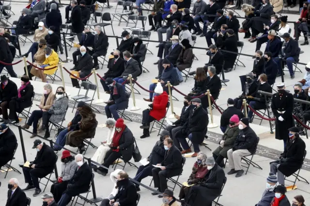 General view of audience during the inauguration of Joe Biden - with people seated in two seats near each other, socially distanced spaced out