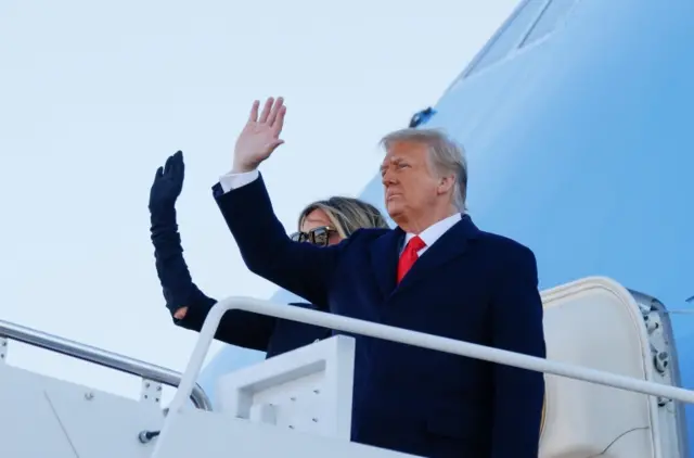 President Donald Trump and first lady Melania Trump wave as they board Air Force One at Joint Base Andrews, Maryland