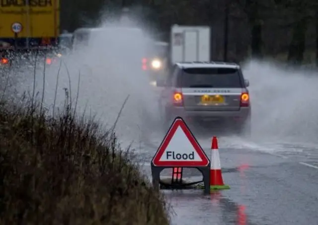 Cars in flood spray