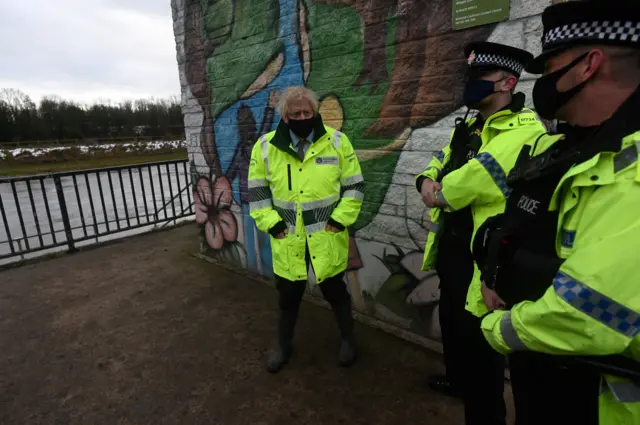 Prime Minister Boris Johnson and police officers