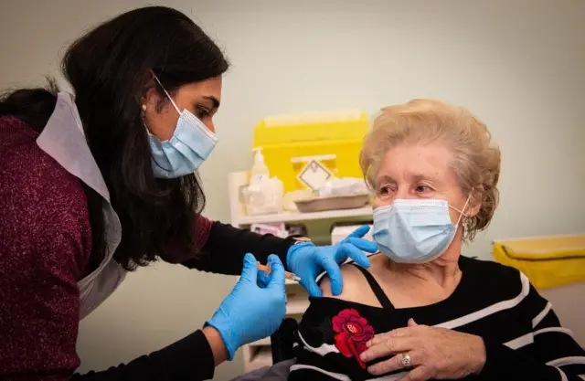 A woman having a vaccine