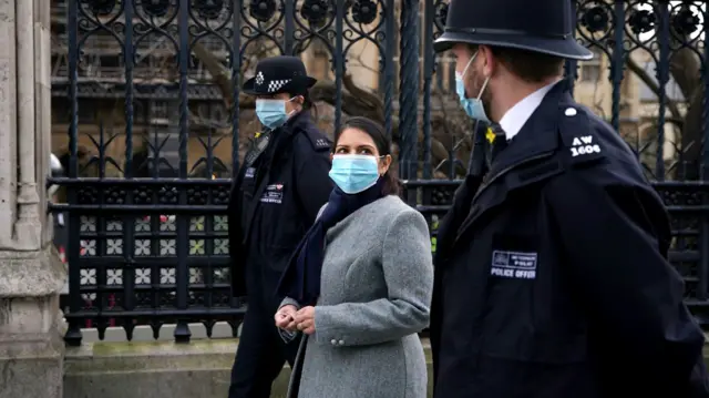 Home Secretary Priti Patel walks towards Westminster Bridge, whilst on patrol with Metropolitan Police officers in central London, to hear about about Covid enforcement