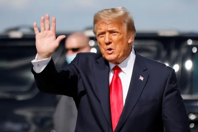 Donald Trump waves as he arrives at Palm Beach International Airport in West Palm Beach, Florida. Photo: 20 January 2021