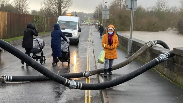 People cross one of the bridges