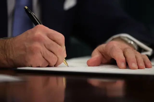 U.S. President Joe Biden prepares to sign a series of executive orders at the Resolute Desk in the Oval Office just hours after his inauguration on January 20, 2021 in Washington, DC