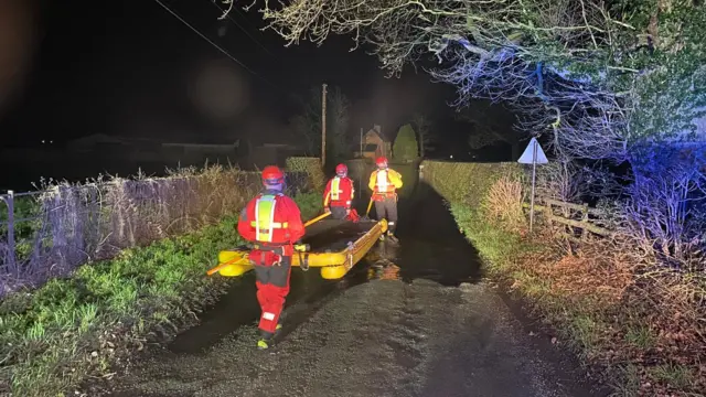 Fire crews with rescue equipment