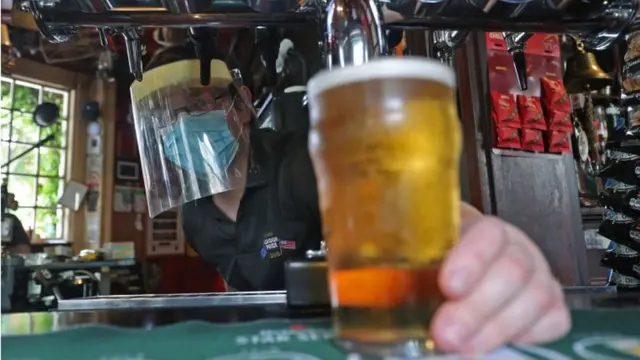 Pint being poured in a pub