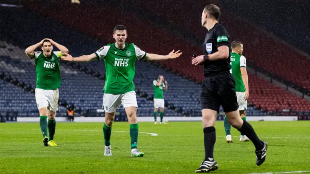 Hibs players plead with referee at Hampden